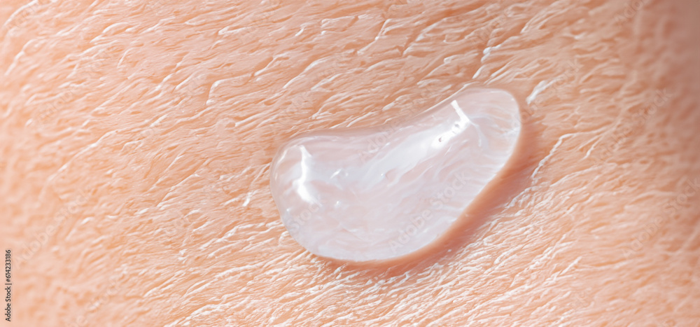 Fototapeta premium Collagen And Hyaluron Serum Gel On Skin. Splashing of Hyaluron gel. Liquid hyaluronic acid gel on skin. Cosmetic water gel texture on human skin background. Textured background. skin care product.