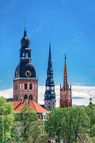 Obraz na płótnie View of row of towers and spires in Riga, Latvia. Copy space in clear sky. w salonie