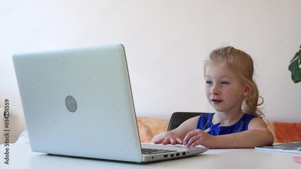 Girl watching educational video on laptop. Girl watching educational video on laptop.