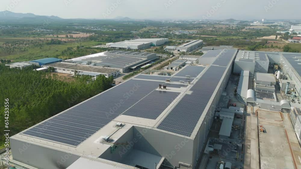 Aerial view of solar panels or solar cells on the roof of factory building rooftop. Power plant, renewable clean energy source. Eco technology for electric power in industry.