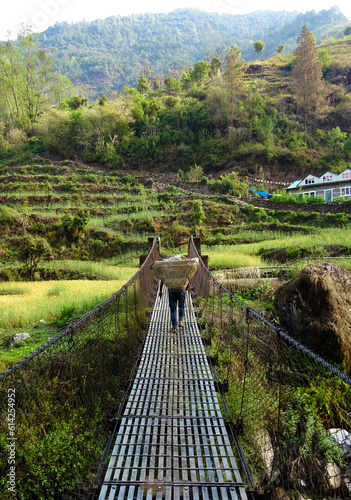 suspension bridge view with rice fields