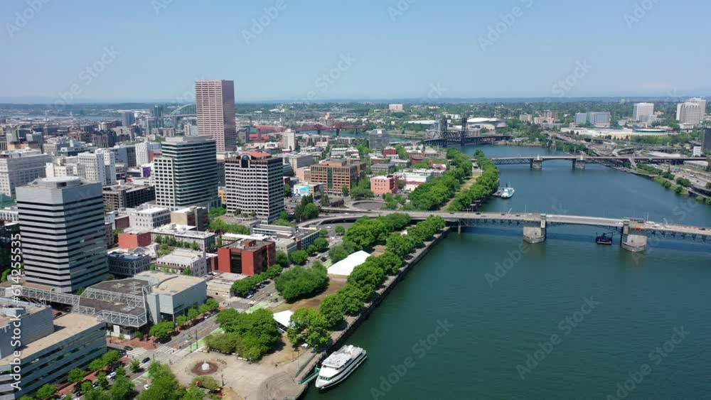 Portland Oregon, USA - 23-7-1, aerial backwards flight above Willamette River from Morrison Bridge with a left panning view across Downtown Portland, aerial video footage