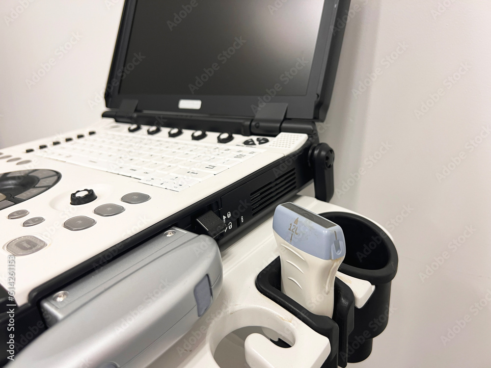 Naklejka premium Close up view of a medical ultrasound probe and the equipment in the background