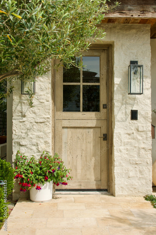 limestone cottage with sun bleached wood front door