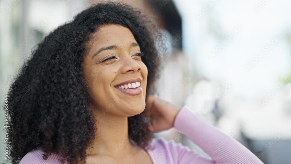 African american woman smiling confident looking to the side at street