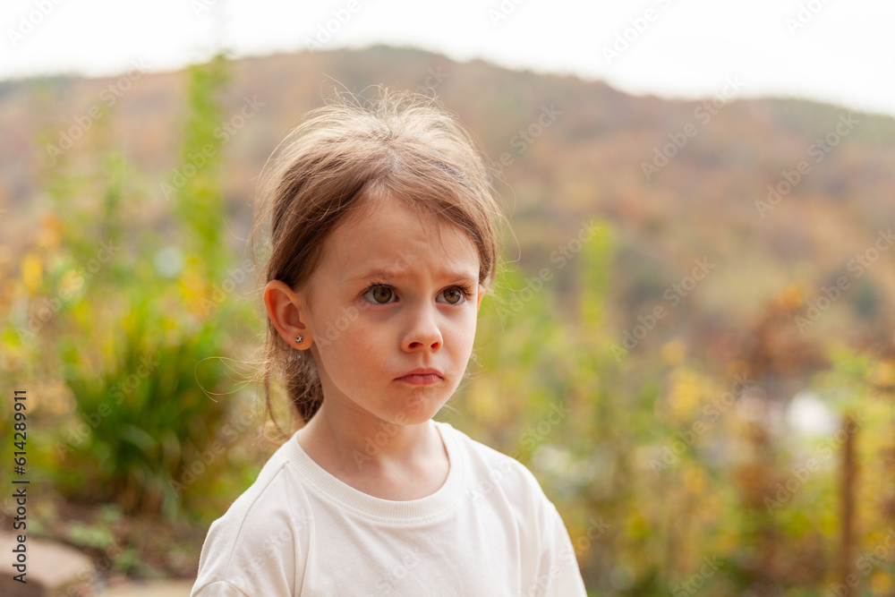 Little girl in a white T-shirt on a background of autumn nature Little girl in a white T-shirt on a background of autumn nature