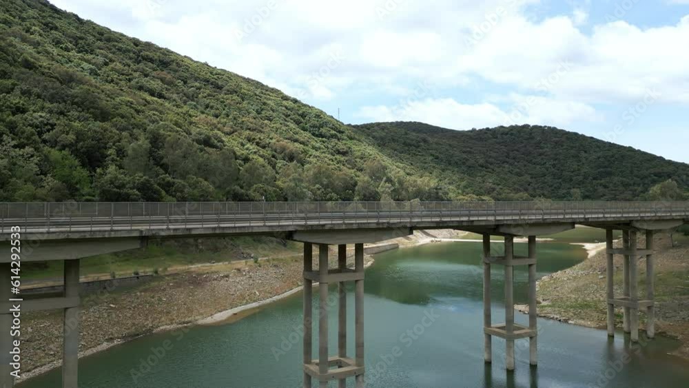 Aerial shot of a minibus crossing a bridge. Aerial shot of a minibus crossing a bridge.