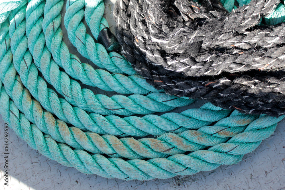 Textured ropes, coiled ropes, fisherman's boat