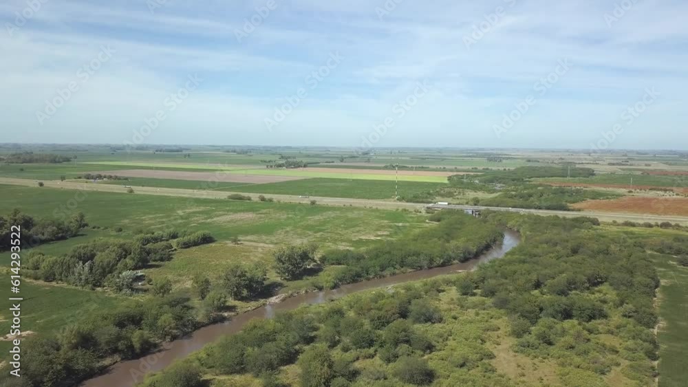 Drone flight over stream and highway crossing in countryside Drone flight over stream and highway crossing in countryside