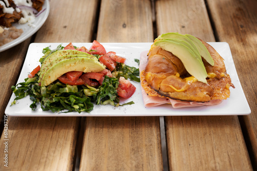 close up detail of a fresh and balanced breakfast in a white duck on a wooden table outdoors