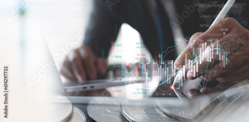 Businessman using digital tablet analyzing stock market data with economic graph growth chart, financial report, market research and currency exchange. Business finance and investment concept