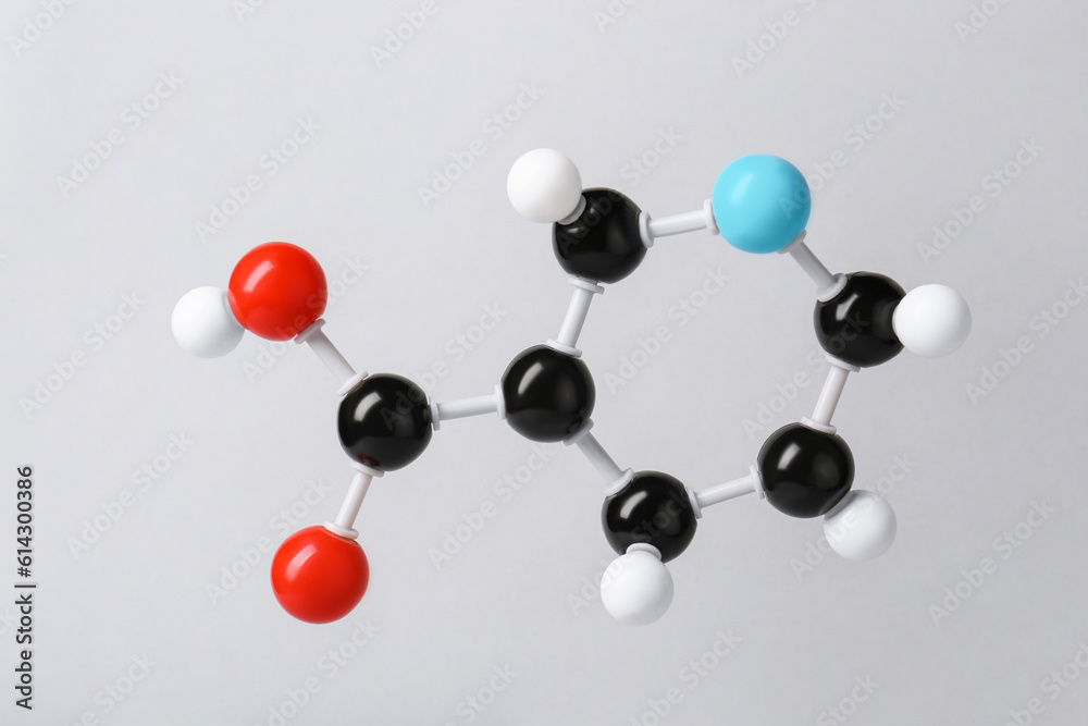 Molecule of vitamin B3 on light grey background. Chemical model