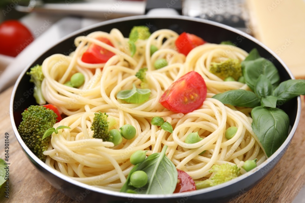 Delicious pasta primavera in frying pan on table, closeup