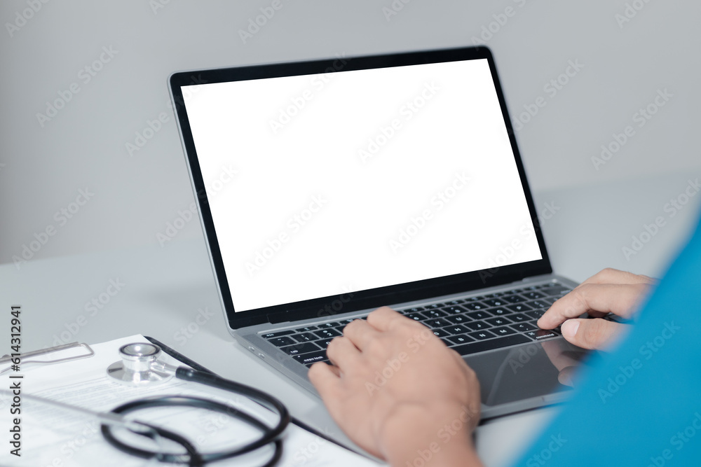 Mockup of doctor using and typing on laptop with blank white desktop screen. Mockup of doctor using and typing on laptop with blank white desktop screen.