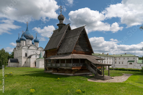 View of the wooden St. Nicholas Church from the village of Glotovo transported to the territory of the Suzdal Kremlin on a sunny summer day, Suzdal, Vladimir region, Russia photo