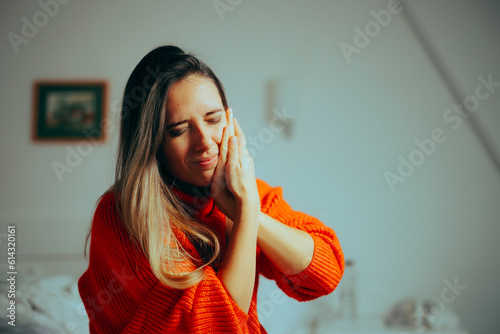 Unhappy Woman Suffering a Toothache Feeling in Pain. Stressed dental patient feeling sore at home after treatment 
