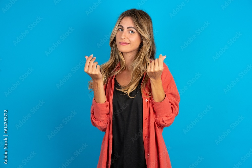 young beautiful blonde woman wearing overshirt doing money gesture with hands, asking for salary payment, millionaire business young beautiful blonde woman wearing overshirt doing money gesture with hands, asking for salary payment, millionaire business
