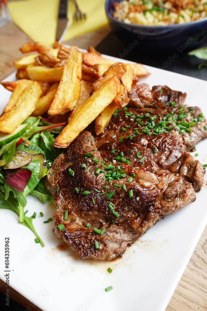 Photo of steak and fries on the table Photo of steak and fries on the table