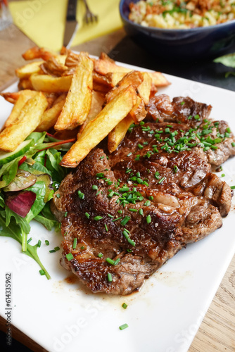 Photo of steak and fries on the table 
