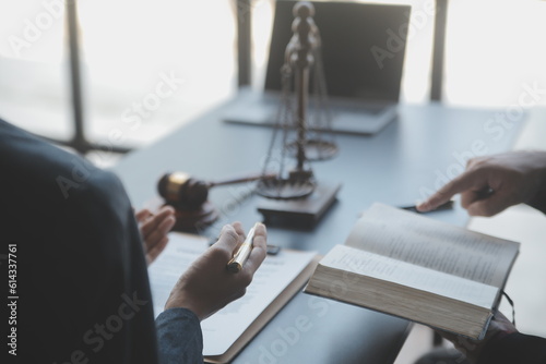 Business and lawyers discussing contract papers with brass scale on desk in office. Law, legal services, advice, justice and law concept picture with film grain effect