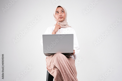 Muslimah doing her work with laptop isolated white background