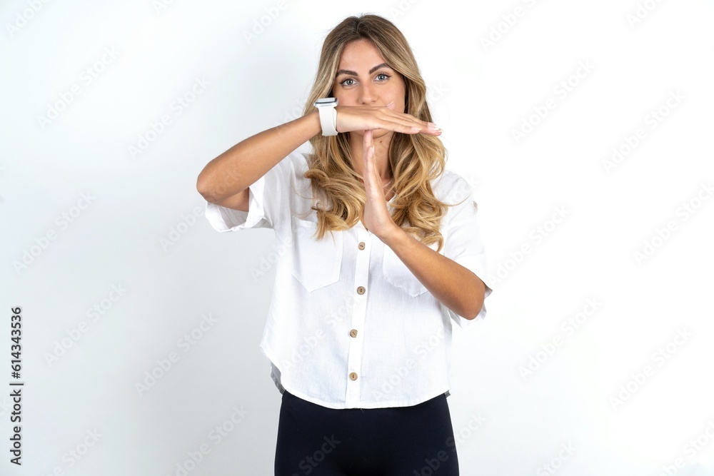 Young caucasian business woman wearing white shirt over white background being upset showing a timeout gesture, needs stop, asks time for rest after hard work, Young caucasian business woman wearing white shirt over white background being upset showing a timeout gesture, needs stop, asks time for rest after hard work,