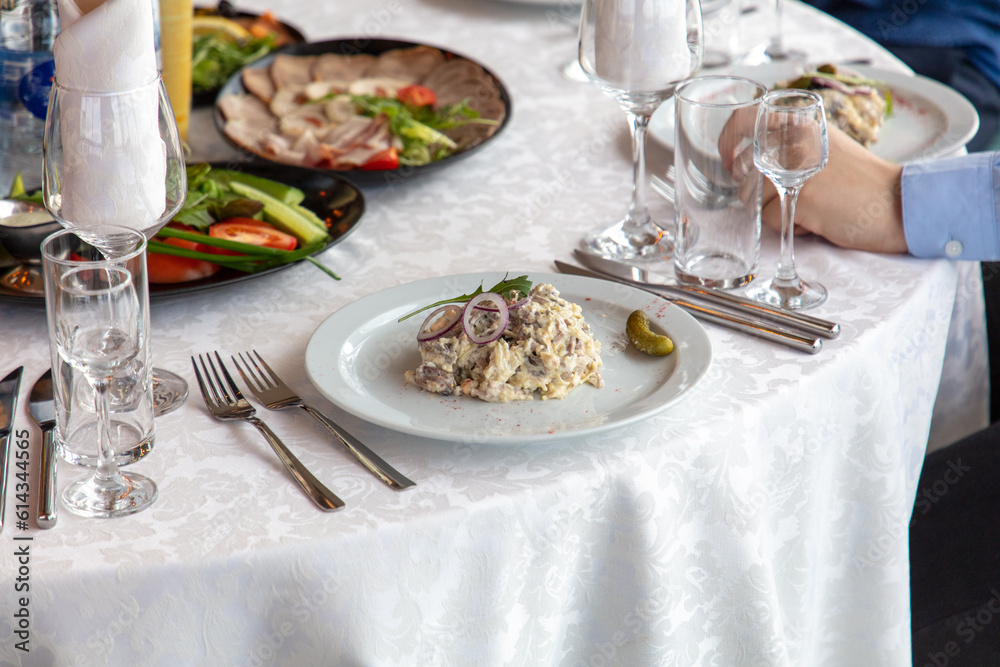 Mushroom salad on a white plate with fork and knife Mushroom salad on a white plate with fork and knife