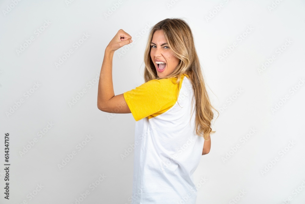 Profile side view portrait Young beautiful woman wearing football T-shirt over white background celebrates victory Profile side view portrait Young beautiful woman wearing football T-shirt over white background celebrates victory