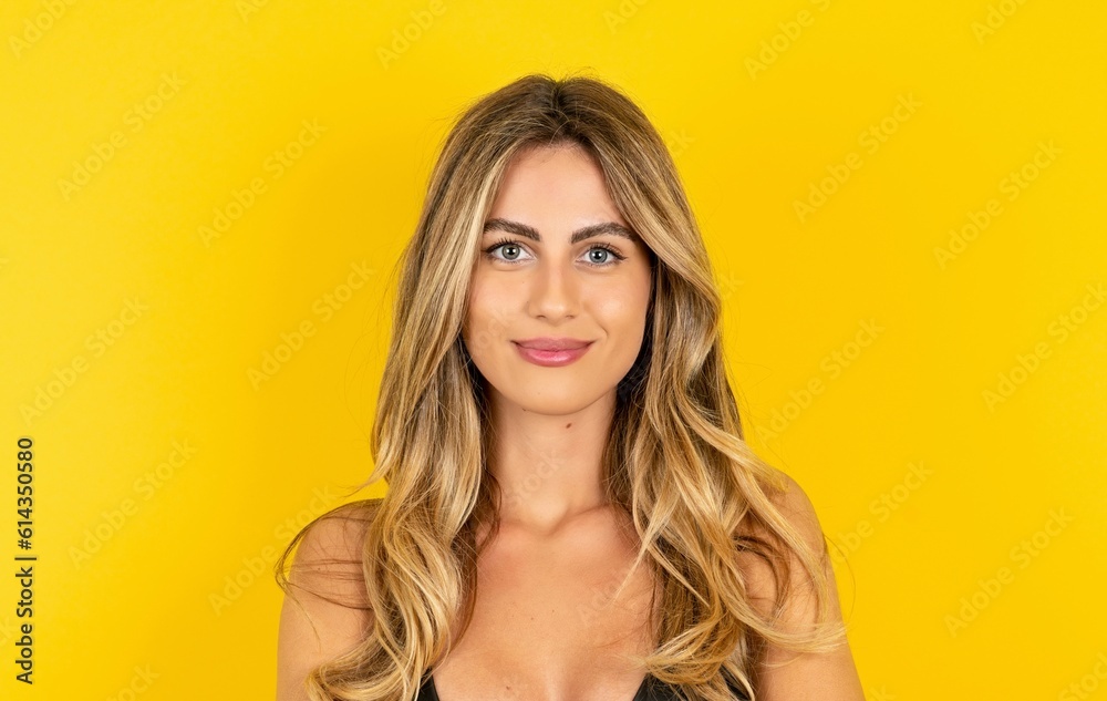 Self confident serious calm MODEL stands with arms folded. Shows professional vibe stands in assertive pose.