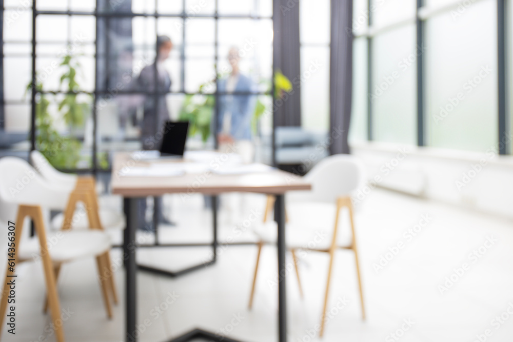Blurred image of business people standing in the office Blurred image of business people standing in the office