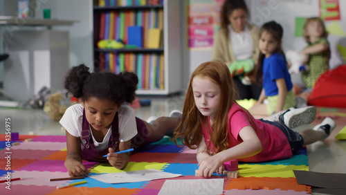Cute primary school age girls of mixed race studying together. 