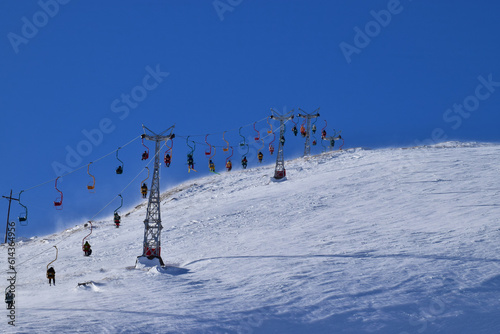 View of cable car with skiers on Mount Cheget