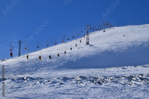 Panorama of the cable car with skiers on Mount Cheget
