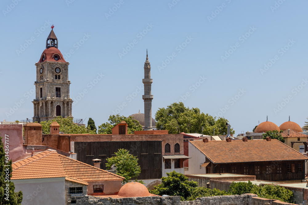 Church tower and minaret tower in old town Rhodes, Greece