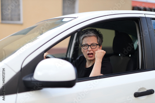 Angry female driver swears in the car.