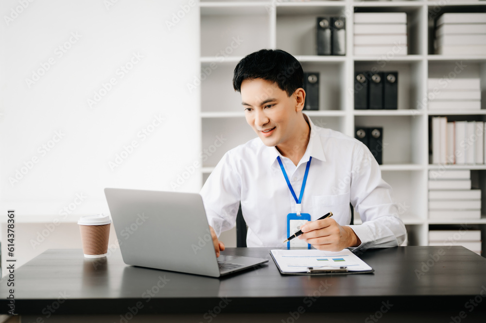 Businessman using tablet and laptop for doing math finance on an office desk, tax, report, accounting, statistics, and analytical research concept in office