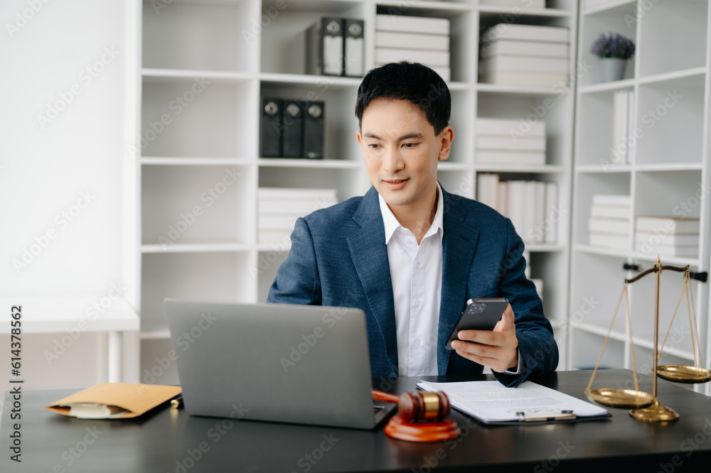 Attractive young lawyer in office Business man and lawyers discussing contract papers laptop and tablet with brass scale on desk in modern office. Law, legal services, advice,. Attractive young lawyer in office Business man and lawyers discussing contract papers laptop and tablet with brass scale on desk in modern office. Law, legal services, advice,.