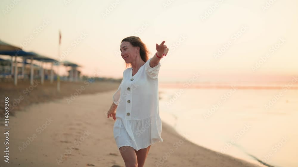 Joyful happy carefree woman running turning jumping on ocean sandy beach on summer vacation. Satisfied relaxed blonde female resting on luxury resort feeling freedom happiness. Travel tourism concept. Joyful happy carefree woman running turning jumping on ocean sandy beach on summer vacation. Satisfied relaxed blonde female resting on luxury resort feeling freedom happiness. Travel tourism concept.