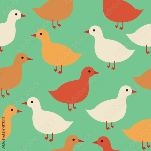 cute colorful ducks on green background seamless vector pattern
