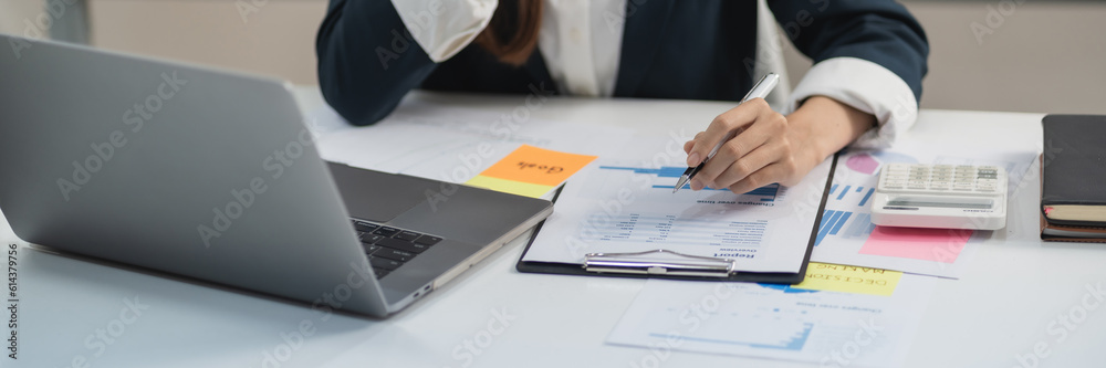 Business analyst calculating turnover figures in office.. Business analyst calculating turnover figures in office..