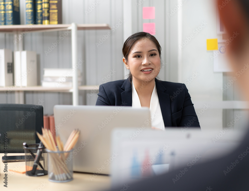 Businesswoman sitting in conference room talking explaining brainstorming business strategy. Young Asian professional business woman or boss working in corporate office. Entrepreneur lifestyle. Businesswoman sitting in conference room talking explaining brainstorming business strategy. Young Asian professional business woman or boss working in corporate office. Entrepreneur lifestyle.
