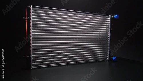 a new aluminum radiator for cooling antifreeze in the car engine photo