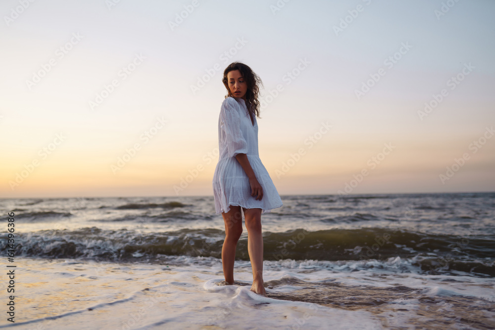 A young woman enjoying a relaxing holiday at the beautiful seaside.  Summer time. Travel, weekend, relax and lifestyle concept.