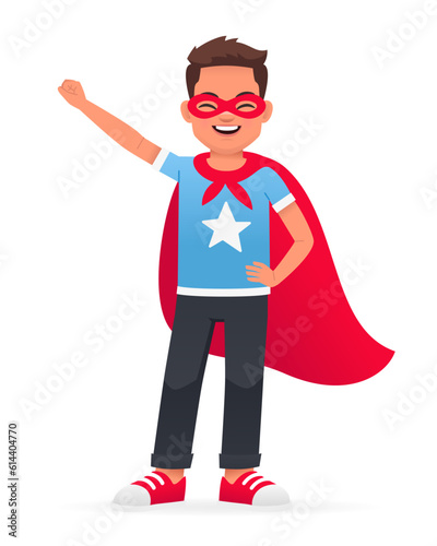 A little superhero. A happy boy in a red raincoat and a red mask. A beautiful cute white schoolboy kid in a blue T-shirt.