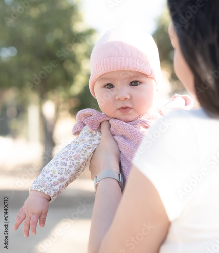 pure joy as a young Asian Chinese mother lovingly plays with her little baby girl, creating a lasting affection happiness bond -  motherhood beauty and childhood innocence