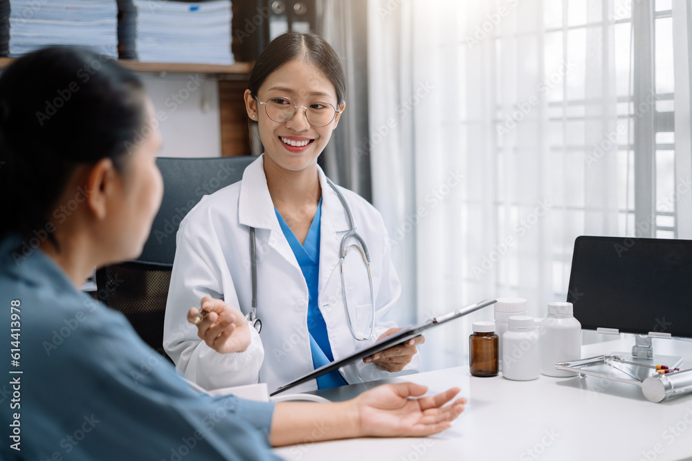 Female doctor checking old woman blood pressure at clinic and filling patient history in the morning. Female doctor checking old woman blood pressure at clinic and filling patient history in the morning.