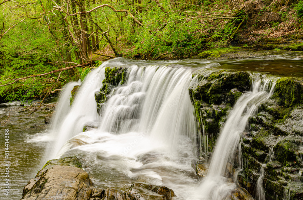 Obraz premium A beautiful slow motion long shutter speed waterfall in Wales forest. Brecon Beacons - UK, England