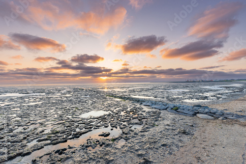 Beautiful sunset landscape of the Wadden sea UNESCO Worl heritage site in The Netherlands photo
