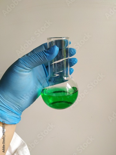 hand holding tube with liquid