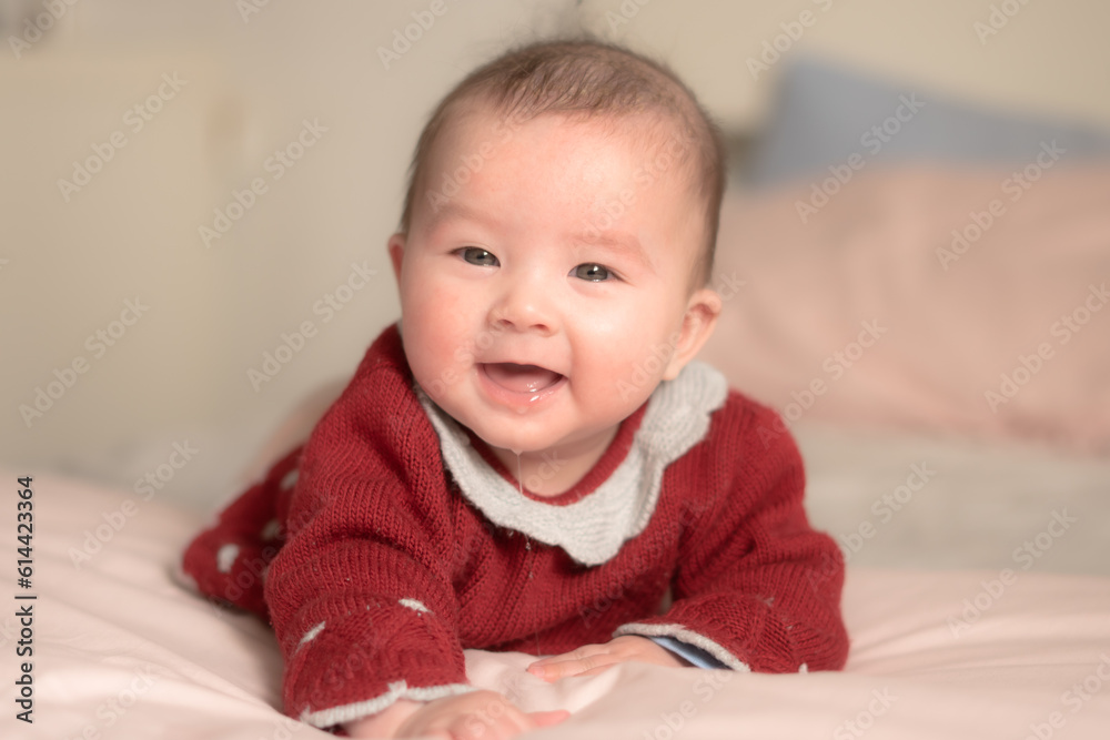 adorable and happy 5 months old baby girl gleefully discovers boundless joy while playfully exploring her bed. Surrounded by the warm glow of natural light the little on smiles cheerfully adorable and happy 5 months old baby girl gleefully discovers boundless joy while playfully exploring her bed. Surrounded by the warm glow of natural light the little on smiles cheerfully